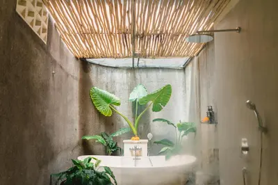 a bathroom with a sink and a potted plant at Goestlie Berawa in Canggu