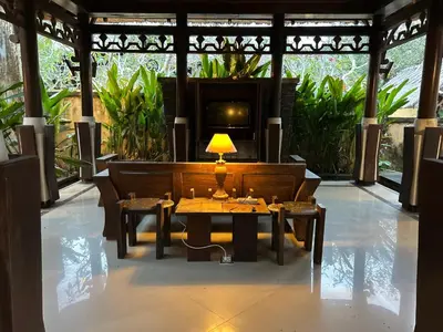 a table with a lamp on top of a room at Mai Villa in Jimbaran