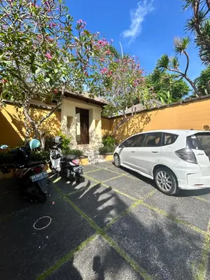 a white car parked in a parking lot next to a house at Mai Villa in Jimbaran
