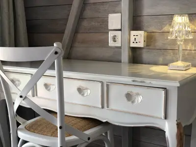 a white desk with a chair and a lamp at Bali WOW! Bungalows, Nusa Dua Benoa in Nusa Dua
