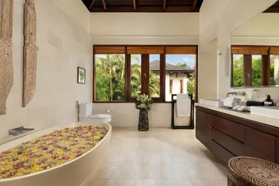 a bathroom with a large tub in the middle at The Suar Seminyak by Nakula in Seminyak