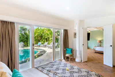 a room with a view of the pool and a hotel at La Villa Oberoi (6 BR) in Seminyak