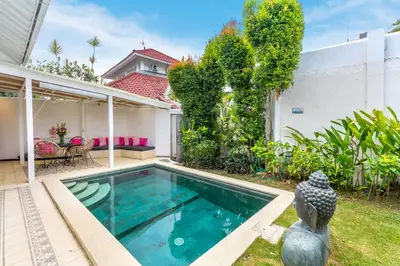 a swimming pool in the backyard of a house at La Villa Oberoi (2 BR) in Seminyak