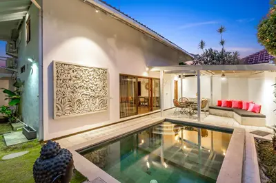 a swimming pool in the backyard of a house at La Villa Oberoi (2 BR) in Seminyak
