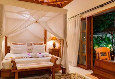 a bedroom with a bed with a canopy at Villa Dayak in Seminyak