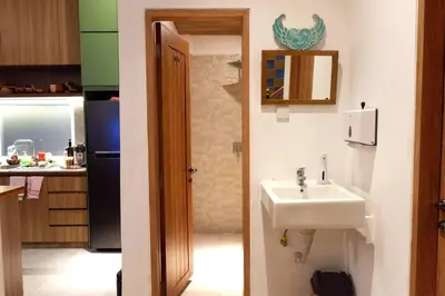 a small kitchen with a sink and a refrigerator at Villa Bale Damai Denpasar in Seminyak