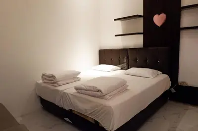 a bedroom with a bed with towels on it at Villa Bale Damai Denpasar in Seminyak