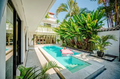 a swimming pool in the middle of a house at Lalita Villas Seminyak in Seminyak