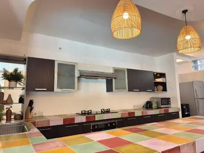 a large kitchen with a checkered floor at Lalita Villas Seminyak in Seminyak