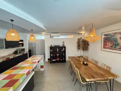 a dining room with a wooden table and chairs at Lalita Villas Seminyak in Seminyak