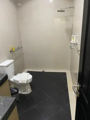 a bathroom with a white toilet and a shower at 5 Bedroom Holiday Villa - Kuta Regency B8 in Kuta