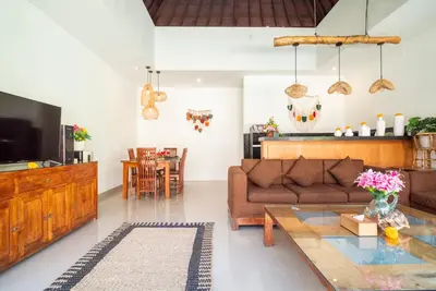 a living room with a couch and a table at Villa bella wilson in Seminyak