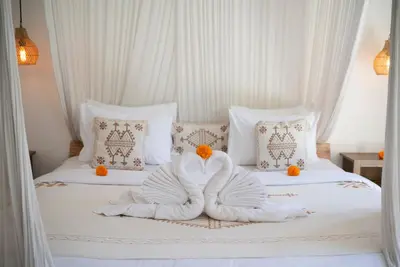 two swans made out of towels on a bed at Villa bella wilson in Seminyak