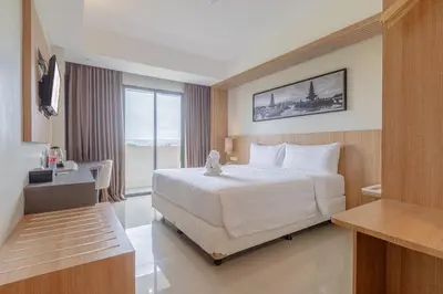 a bedroom with a large white bed in a room at Horison Le Aman Bali in Jimbaran