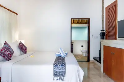 a bedroom with two beds with a phone on it at Villa Tunjung Batubelig Canggu in Canggu