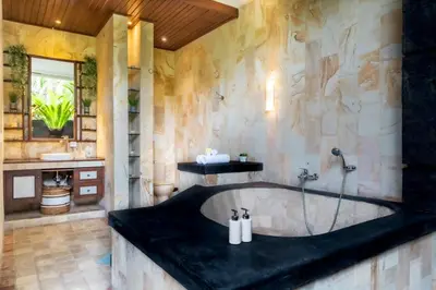 a bathroom with a bath tub in a room at Villa Tunjung Batubelig Canggu in Canggu