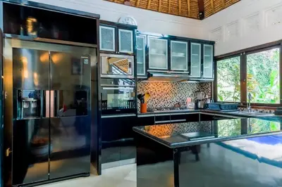 a kitchen with a large stainless steel refrigerator at Villa Tunjung Batubelig Canggu in Canggu