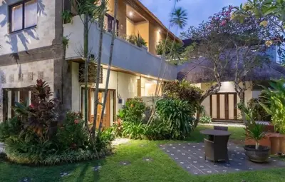 a house with a garden in front of it at Villa Tunjung Batubelig Canggu in Canggu