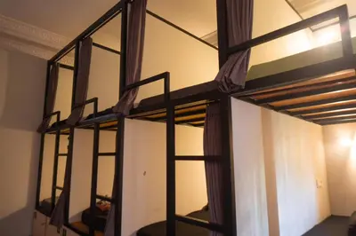 a room with two bunk beds in a room at Sunshot Hostel in Legian