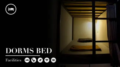 a bedroom with a bunk bed in a dark room at Sunshot Hostel in Legian