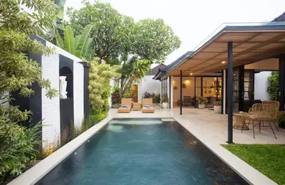 a swimming pool in the backyard of a house at The Kon's Villa Bali Seminyak in Seminyak