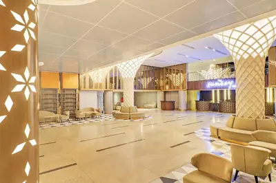 a lobby with chairs and a waiting room at Sunday Hotel Arshika Sunset Road in Kuta