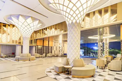 a lobby of a hotel with chairs and tables at Sunday Hotel Arshika Sunset Road in Kuta