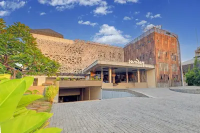 a large brick building with a building at Sunday Hotel Arshika Sunset Road in Kuta
