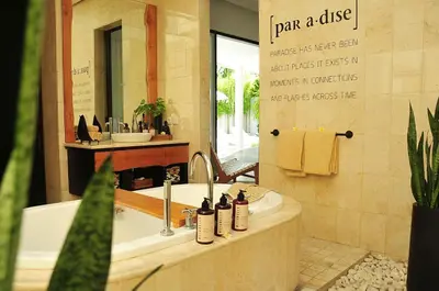 a bathroom with a tub and a sink and a mirror at Villa Zensa @ The Residence Seminyak in Seminyak