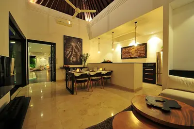 a kitchen and living room with a table and chairs at Villa Zensa @ The Residence Seminyak in Seminyak