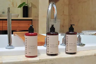 two bottles of soap sitting on a bathroom sink at Villa Zensa @ The Residence Seminyak in Seminyak