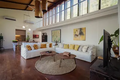 a living room with a white couch and a table at Bias Villa Seminyak in Seminyak