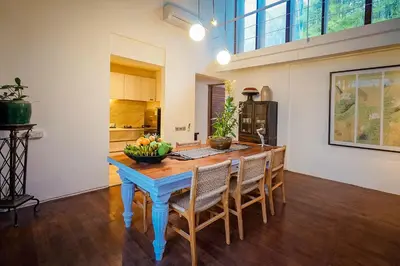 a dining room with a blue table and chairs at Bias Villa Seminyak in Seminyak