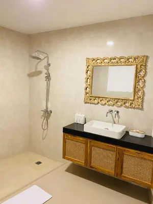 a bathroom with a sink and a mirror on the wall at Casa Praja in Seminyak
