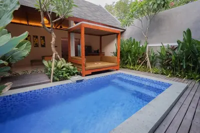a swimming pool in front of a villa at Villa Bulan Bali in Jimbaran