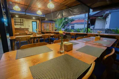 a dining room with tables and chairs with flowers on it at Villa Bulan Bali in Jimbaran