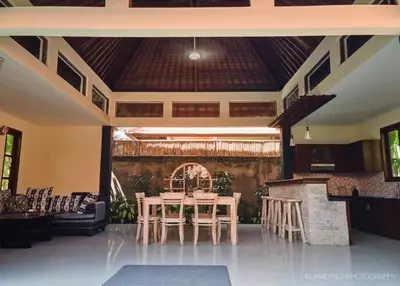a dining room with tables and chairs in a room at Villa Nicola in Seminyak
