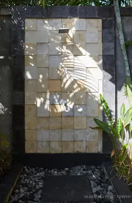 a brick wall with a shadow on it at Villa Nicola in Seminyak
