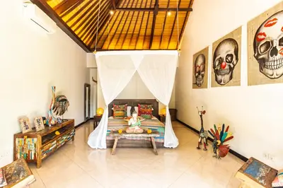 a bedroom with a bed with a canopy at PROMO Tropical 3 BD Villa with office and parking in Kerobokan
