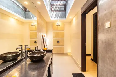 a bathroom with two sinks and a skylight at PROMO Tropical 3 BD Villa with office and parking in Kerobokan