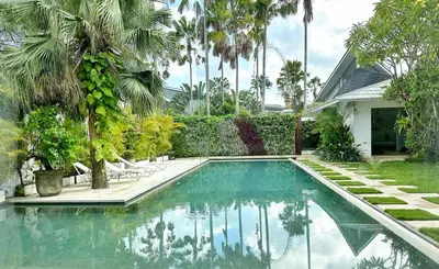 a swimming pool in the backyard of a house at Villa Jumah in Canggu