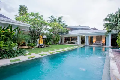 an exterior view of a villa with a swimming pool at Villa Jumah in Canggu