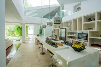 a kitchen with a large white counter with bananas on it at Villa Jumah in Canggu