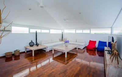 a living room with a couch and two tables at Villa Jumah in Canggu