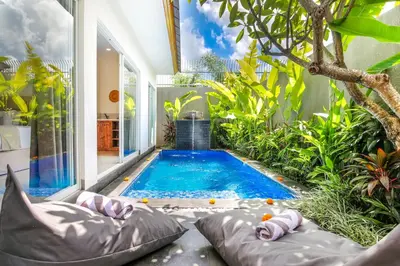 a swimming pool in the middle of a house at Le Cielo Romantic Villas by Maviba in Seminyak