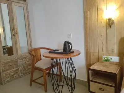 a tea kettle sitting on a table in a room at Oki Taru Residence in Kuta