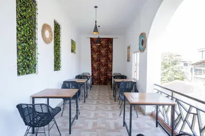a row of tables and chairs in a restaurant at Oki Taru Residence in Kuta