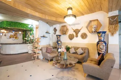 a living room with couches and a table in a room at Oki Taru Residence in Kuta