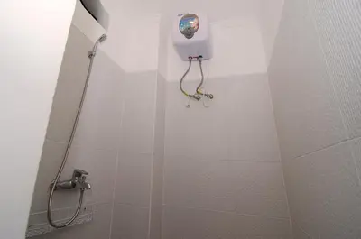 a bathroom with a shower stall with a shower at Sanur Guest House in Sanur