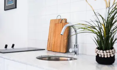 a kitchen counter with a sink and a cutting board at Villa Bella Seminyak in Seminyak